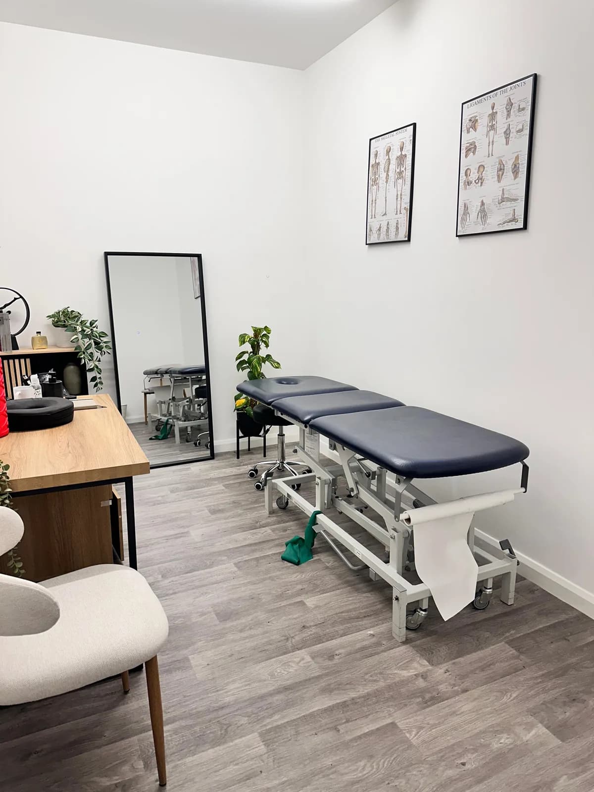 The treatment room at Letts Perform Physiotherapy — hydraulic treatment couch and anatomy charts The treatment room at Letts Perform Physiotherapy — hydraulic treatment couch and anatomy charts