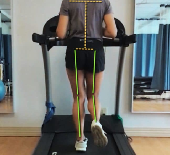 Runner mid-stride captured from behind for gait analysis Runner mid-stride captured from behind for gait analysis