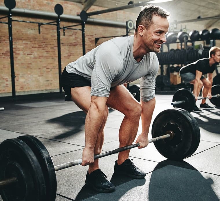 Athlete training in a well-equipped gym with strength and conditioning equipment Athlete training in a well-equipped gym with strength and conditioning equipment